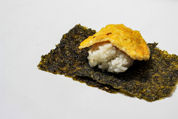 Nori seaweed with rice and egg isolated on white background. Nori Japanese Food. Dried seaweed sheets. © Dinar Budiman