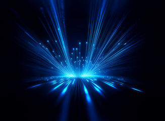 Abstract digital art depicting a burst of vibrant blue light emanating from a central point, creating a dynamic and energetic composition on a dark background.  The light streaks radiate outwards, sug
