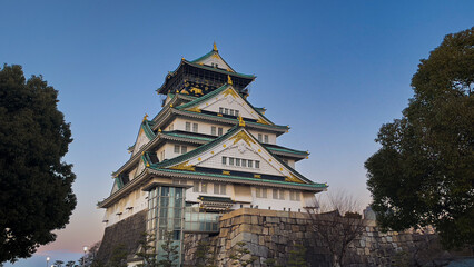 Captivating Sunset Over Historical Osaka Castle Japan - Serene Architectural Landscape Viewpoint Showcasing Cultural Heritage