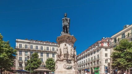 Camoes Monument in Luis de Camoes Square in the Chiado neighborhood timelapse hyperlapse. It comprises a tall bronze statue of the national poet. Walking area with historic buildings. Lisbon, Portugal