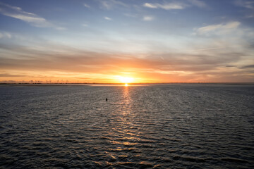 Landscape near Dagebüll. Nature with sunrise on the North Sea coast. Rising sun on the sea.
