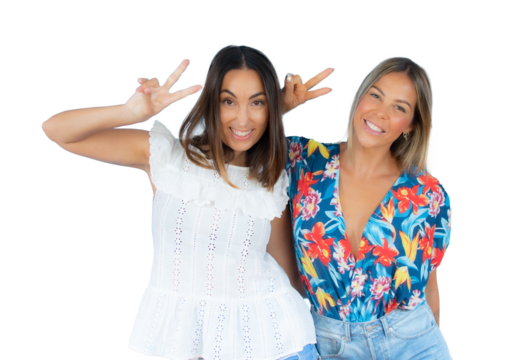 Two smiling young women posing together showing peace symbol standing isolated over transparent background. PNG transparent.