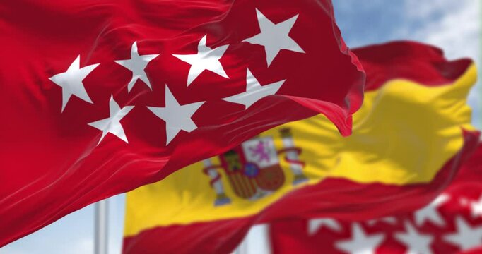 Detail of the Community of Madrid flag waving with national spanish flag