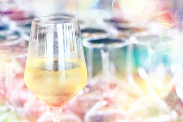 a glass of white wine served in a restaurant, abstract background of a summer restaurant