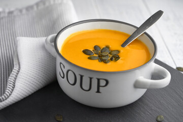 Bowl of warm and Comforting Roasted Pumpkin Soup with Toasted Pumpkin Seeds. Homemade Pumpkin Soup for winter or autumn days