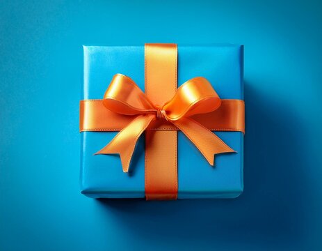 a bright blue gift box with an orange ribbon