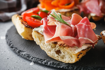 delicious Italian bruschetta with tomatoes salmon and prosciutto
