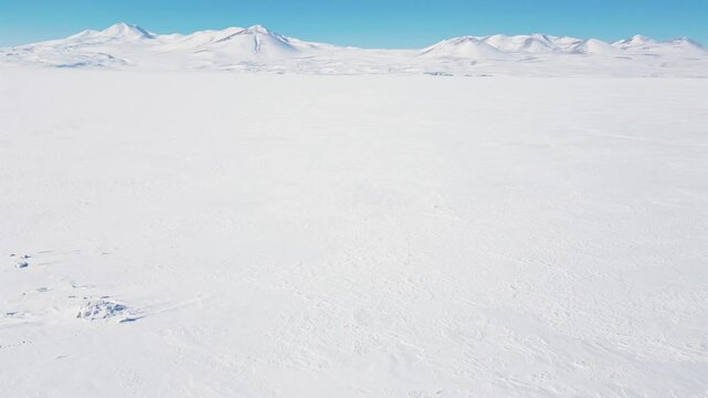 Aerial panoramic view of frozen Paravani lake in Georgia