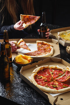 young people relaxing at a party with beer and pizza