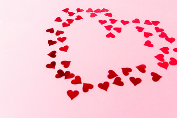 Valentines postcard background. Stylish red hearts confetti frame on pink background with copy space. Happy valentines day. Love banner