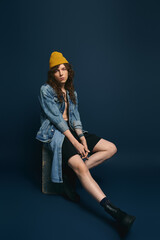 Fashionable young man showcases modern style in a chic studio setting with vibrant colors