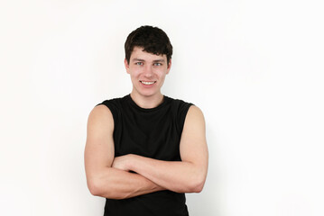 A confident man with a casual stance and friendly smile wearing a black shirt on a white background, emphasizing confidence, and positivity. The guy is confident in future because he found job