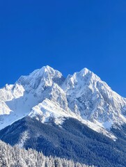 Obraz premium Majestic snow capped mountain peak against a vibrant blue sky