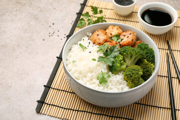 Tasty rice with broccoli and chicken served on grey table, closeup. Space for text