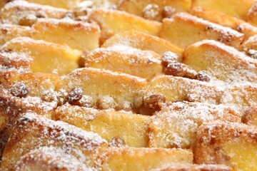 Delicious bread pudding with raisins and powdered sugar, closeup