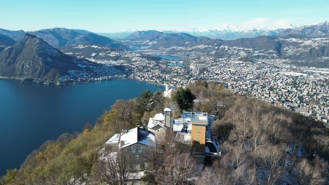 Aerial view of bre mount and st mary church overlooking the beautiful lake and cityscape, lugano, switzerland.
