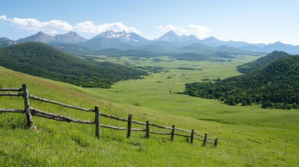 Mountain valley vista, green pasture, wooden fence, summer