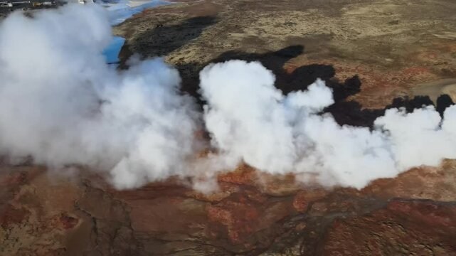 Aerial view of gunnuhver hot springs with steam and geothermal features in rugged volcanic landscape, reykjanes peninsula, iceland.