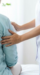 Obraz premium Therapist comforting elderly patient with gentle touch in medical office setting