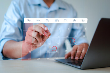 Business planning calendar concept, work schedule, businessman using pen to write on calendar on virtual screen and organize schedule and important dates, meeting time management.