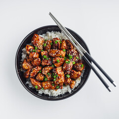 delicious juicy Japanese teriyaki chicken on rice on a white background