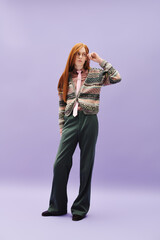 Stylish queer young man poses confidently against a pastel backdrop