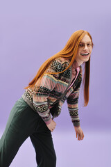 Young queer man expressing joy in a stylish outfit against a vibrant backdrop