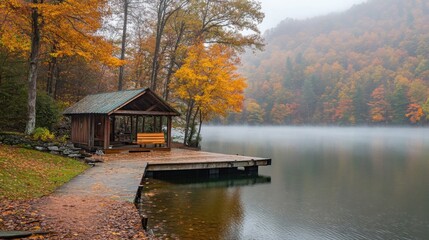 Obraz premium Autumnal Lake Cabin in Misty Mountains