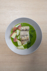 Barramundi and potato in pea spinach green sauce.