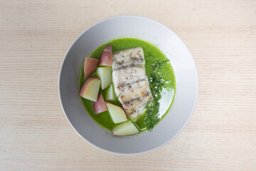 Barramundi and potato in pea spinach green sauce.