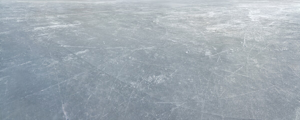  An ice surface as an ice rink with ice skates tracks. Winter sports texture. Big Panorama.