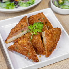 Crispy Fried Shrimp Toast with Fresh Cilantro Garnish - Delicious Asian Appetizer on White Plate, Perfect for Food Blogs and Recipe Websites