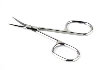 small steel scissors on neutral backdrop