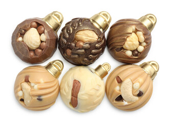 Delicious chocolate in shape of Christmas baubles isolated on white, top view