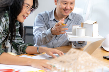 Two young architects working at the office.