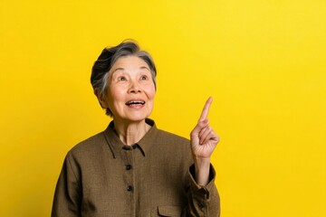 Asian woman portrait, eyes in focus, asian excited elderly smiling man looking up, one hand pointing up, wearing a modern longsleev shirt . 