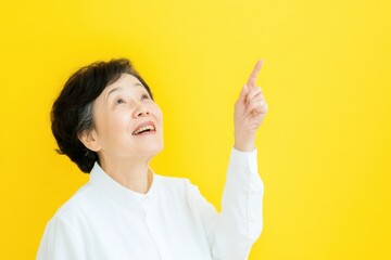 Asian woman portrait, eyes in focus, asian excited elderly smiling man looking up, one hand pointing up, wearing a modern longsleev shirt . 