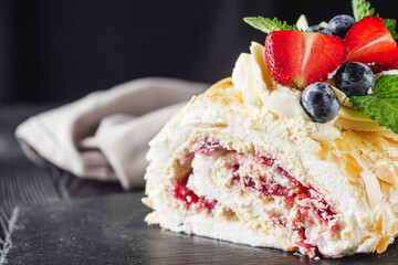beautiful delicious crispy meringue roll on a dark rustic background