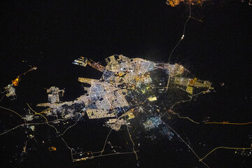 Dhahran city lights at night seen from space. Digital enhancement of an image by NASA.