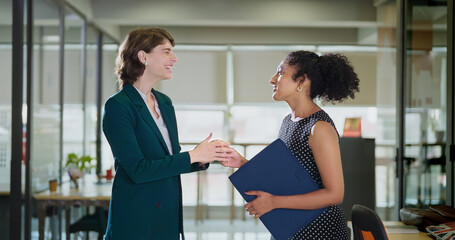 Happy young adult gen z diverse boss woman lady talk gossip day task indoor job office work place female girl expert intern staff hold file speak share blab idea plans enjoy break time have fun joy	