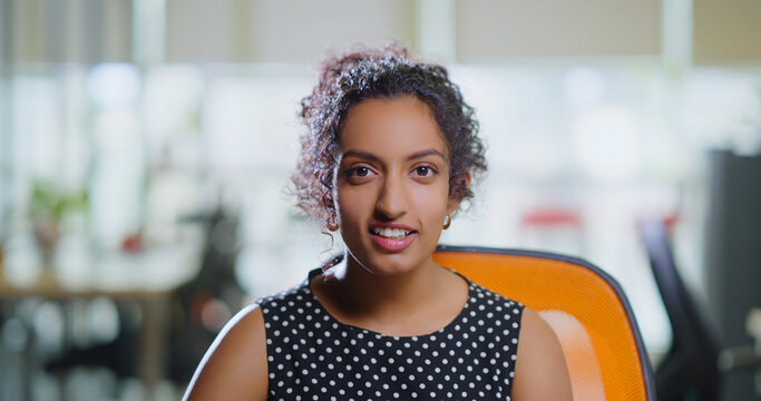 Indian happy young adult gen z expert intern woman lady look cam do day work talk distant client video call Head shot smiling teen girl female teach speak idea share study plan indoor job office place