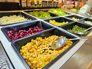 Close up of salad bar. Sweet corn, red bean and others. Vegetable for healthy.