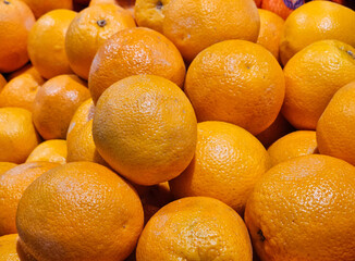 Many organic oranges at supermarket.