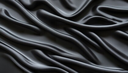 Obraz premium black silk satin background. Soft wavy folds on the fabric.