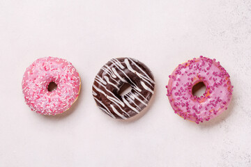 A colorful assortment of vibrant donuts with various toppings arranged