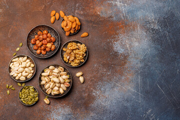 A vibrant assortment of various nuts, including almonds, walnuts, hazelnuts, cashews, and pistachios