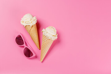A refreshing ice cream cones set against a vibrant pink background