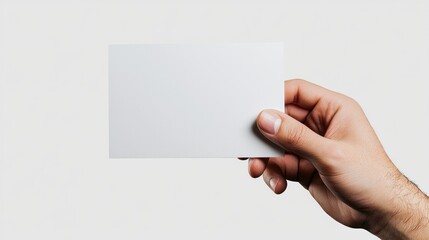 Hand Holding Blank White Card Against Grey Background