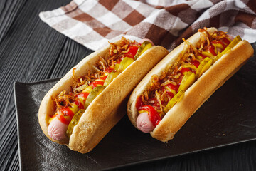fresh juicy traditional hot dog on black wooden rustic background
