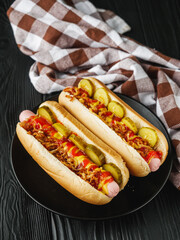fresh juicy traditional hot dog on black wooden rustic background